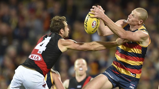 Essendon's Jobe Watson tries to spoil a Sam Jacobs marking attempt. (AAP)