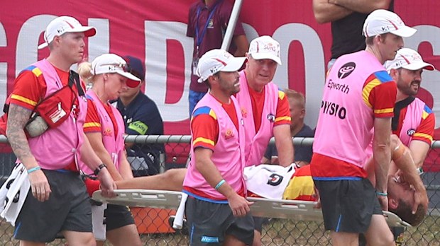Gold Coast Suns' Sam Day is taken from the field after dislocating his hip against Brisbane. (Getty)