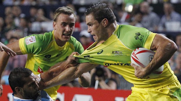 Ed Jenkins tries to break a Pumas' tackle at the Hong Kong Sevens.(AAP) 