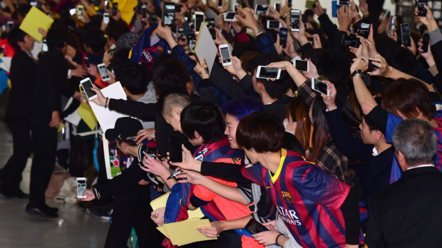 Barcelona fans await their heroes in Japan. (AFP)
