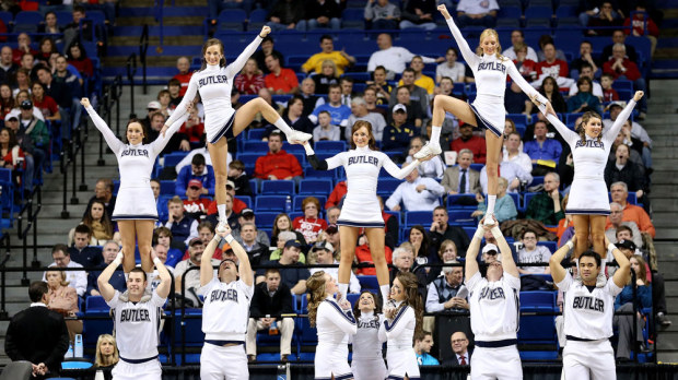 A college cheerleading squad goes through its routine. (AFP)