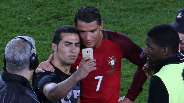 Cristiano Ronaldo poses with a fan (WWOS)