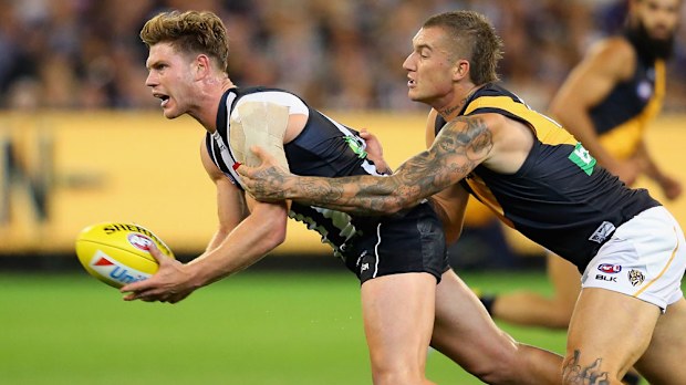 Taylor Adams gets tackled by Dustin Martin. (Getty)