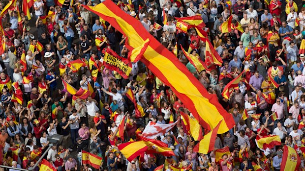 Thousands of pro-Spanish unity supporters donning Spanish flags have rallied in a central Madrid plaza to protest the Catalan regional government's drive to separate from Spain. Writing on one of the flags reads: "Long live the Unity of Spain". (AP)