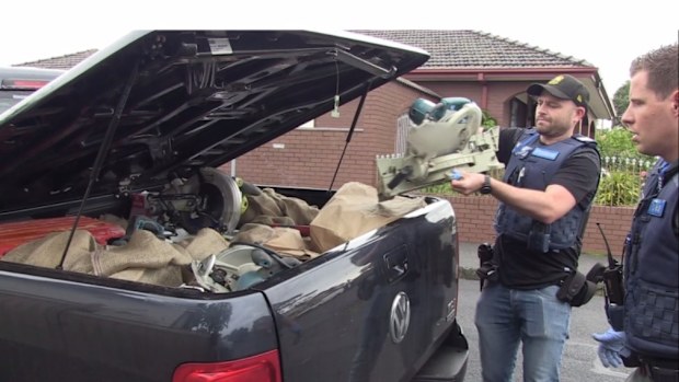 Officers remove the allegedly stolen tools from a ute. (Victoria Police)