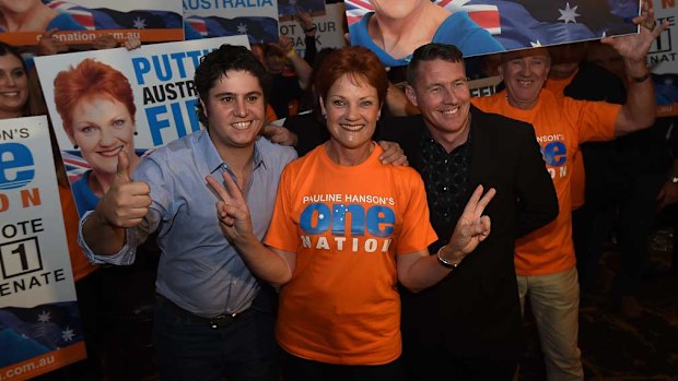  One Nation's Pauline Hanson, Troy Aggett (right) and the party's candidate for Oxley Brad Trussell (left) pose for a photo with supporters during their electon-night function in Ipswich in 2016. (Image: AAP)