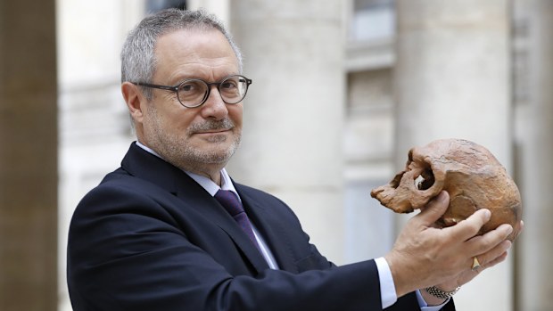 French paleoanthropologist Jean-Jacques Hublin poses with the casting of a skull of Homo Sapiens discovered in Morocco on June 6, 2017 in Paris. (AFP)