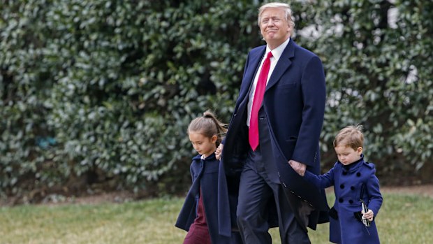 US President Donald J. Trump (C) leaves the Oval Office with two of his grandchildren, Joseph Kushner (R) and Arabella Kushner to board Marine One in March. (AAP)