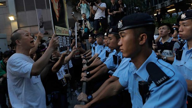 Pro-democracy activists hold photos of detained Nobel Peace Prize Laureate Liu Xiaobo during a protest in Hong Kong. (AAP)
