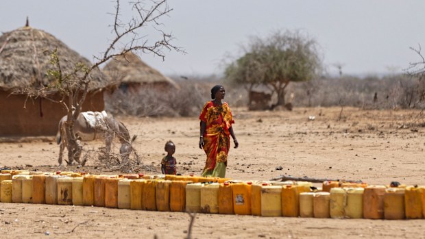 A woman and child wait for water in Kenya. (AFP)