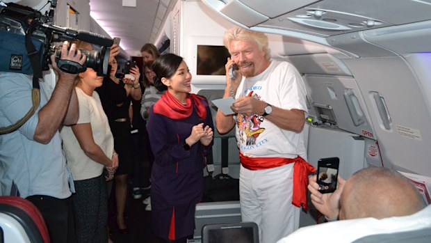 Virgin founder Richard Branson teaching Chinese on the airline's inaugural flight from Melbourne to Hong Kong.