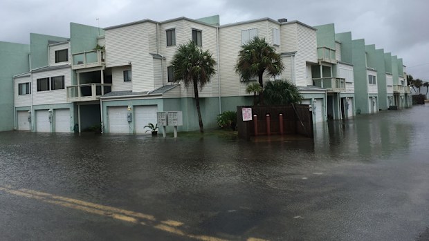 Floodwaters surround a condo in the aftermath of Tropical Storm Nate. (AAP) 