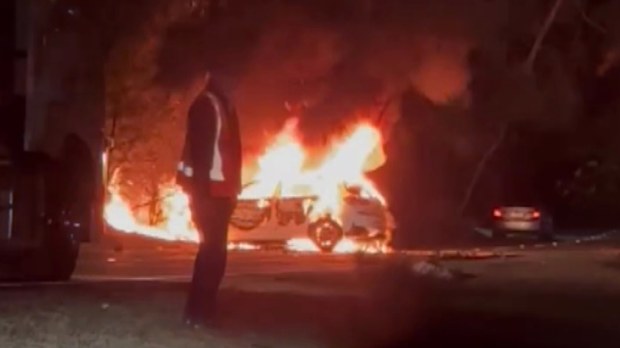 A man has been pulled from the wreck of a fiery crash by paramedics who were driving past the scene in Winston Hills.