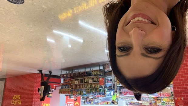 Jo Abi smiling out the front of The Reject Shop to compare prices