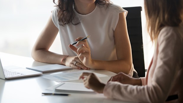 Two diverse serious businesswomen discussing business project working together in office, serious female advisor and client talking at meeting, focused executive colleagues brainstorm sharing ideas (Two diverse serious businesswomen discussing busines