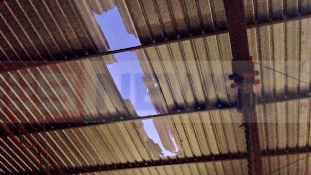 Scientists believe this hole in the roof of a Perth workshop was caused by the sonic boom from a passing meteorite. (9NEWS)