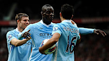 Man City's Sergio Aguero celebrates scoring a goal with James Milner (L) and Mario Balotelli in 2011.
