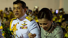 The royal couple greet royalist supporters outside the Grand Palace in Bangkok on November 1.