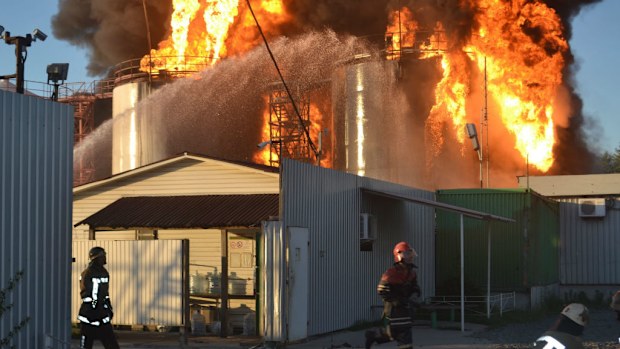 Firefighters tackle a major blaze at a fuel storage depot, near the village of Vasylkiv outside of Kiev. (AAP)