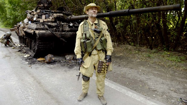 A pro-Russia militant stands guard next to a Ukrainian tank destroyed by separatists in the eastern Ukrainian city of Donetsk. (Alexander Khudoteply/AFP/Getty Images)