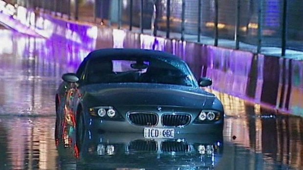 The couple became trapped in their BMW after the heavy downpour. (9NEWS)