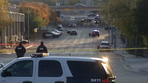 Austin police cordon off the area where the man was shot dead after opening fire on the Mexican consulate. (AAP)