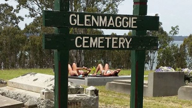 The photo of two women sunbaking at Glenmaggie Cemetery in Victorian. (Supplied)