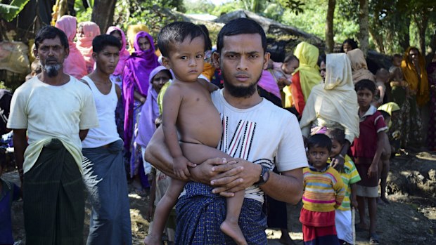 Rohingya refugee and Muslim Mohammad Ayaz stands with his son. Myanmar has reportedly started 'ethnic cleansing' of Rohingya Muslims. (AFP)