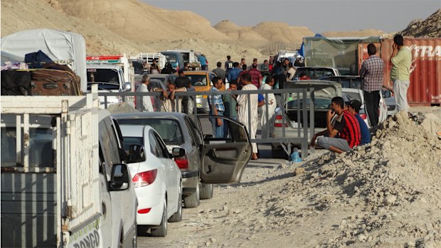 Iraqi family members prepare to leave their hometown of Ramadi. (AAP)