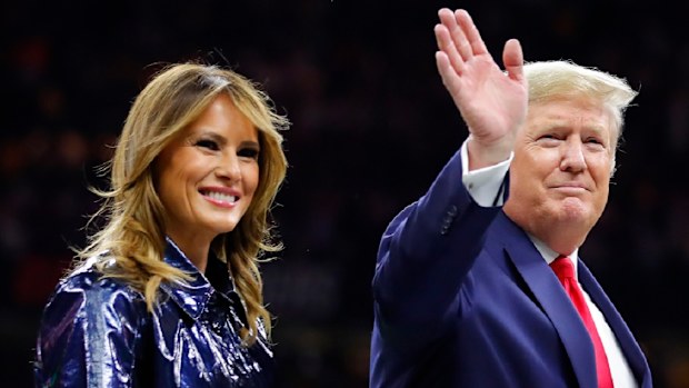 President Trump escorts Melania off the field prior to the College Football Playoff National Championship Game on January 13, 2020.