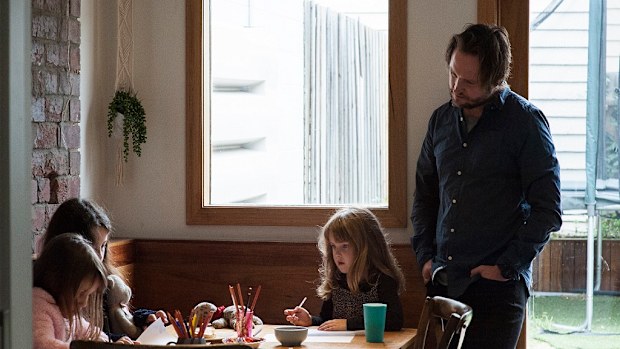 Daniel supervises his daughter's homework activities.
