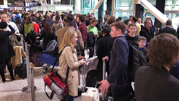 Passengers line up in Terminal Three as they wait for delayed flights at Heathrow Airport. (Getty Images)
