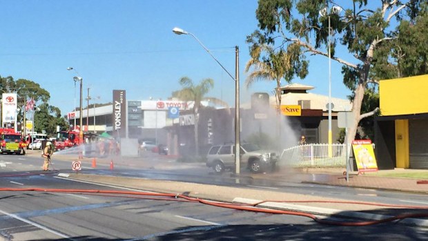 Fire crews spray water on a gas leak in Adelaide. A 200m exclusion zone is in place. (9NEWS/Edward Godfrey)