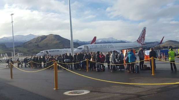 Passengers were evacuated from Queenstown Airport after a message about a bomb was found on board a plane. (Twitter/Louise Cheer)