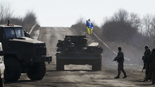 Ukrainian servicemen on an armoured military vehicle as they leave territory around Debaltseve. (AAP)