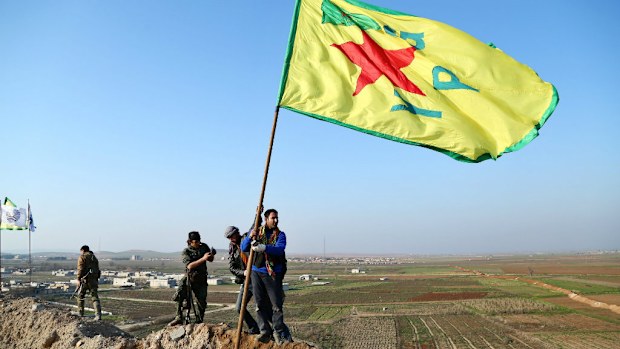 Kurdish YPG soldiers celebrate their victory in Kobane. (AAP)