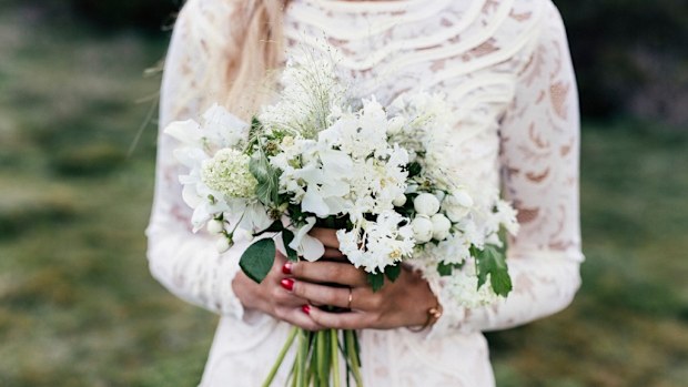 Bride with wedding dress and flowers