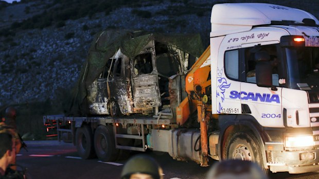 A truck carrying one of three Israeli military vehicles that were hit by an anti-tank missile near the border with Lebanon. (AAP)