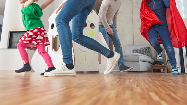 Children and their parents running around at home.