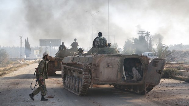Syrian opponents attack an Assad regime-controlled military academy and a neighborhood with tanks. (AFP)