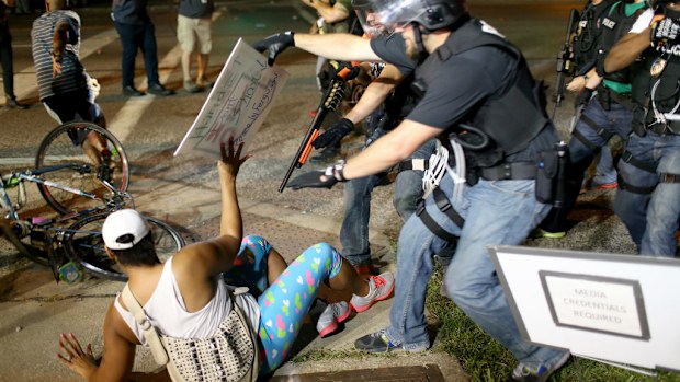Police officers arrest a demonstrator in Ferguson. (Getty)