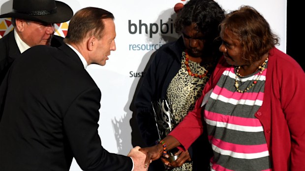 (From left) Professor Mick Dodson with Prime Minister Tony Abbott, and Indigenous Governance Award winners Rachel Tilmauth and April Martin. (AAP)