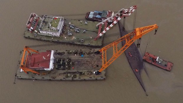 An aerial photo showing rescuers working on a capsized tourist ship in Jianli. (AAP)