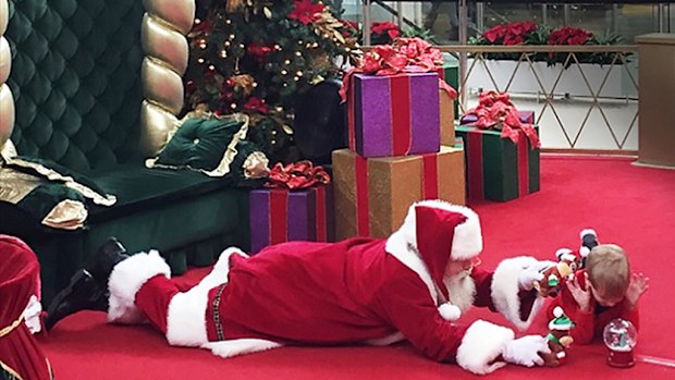 A 'Caring Santa' program in the US gave a boy with autism the chance to have a photo with Santa Clause for the first time. (Autism Speaks/Maeghan Pawley)