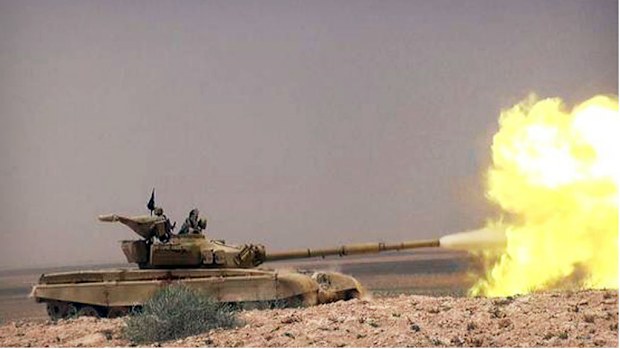 A tank with Islamic State group fighters clashing with Syrian government forces on a road between Homs and Palmyra. (AAP)