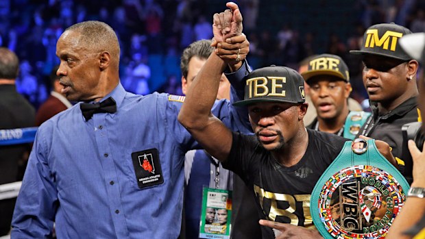 Floyd Mayweather shows off his belts after beating Marcos Maidana. (AAP)