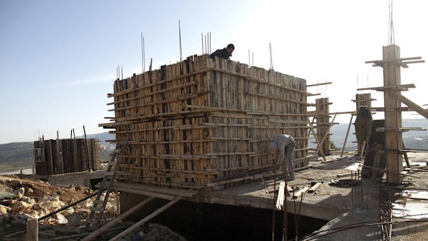 This file photo taken on February 22, 2012 shows Palestinian workers constructing new houses in the Jewish settlement of Shilo in the West Bank. (AFP)
