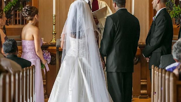 Bride and groom standing at altar during wedding ceremony