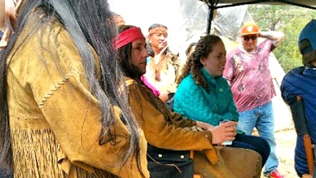Actor Loren Anthony stands next to Adam Sandler in native American costume on the set. (Instagram)