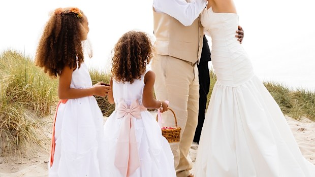 Bride and groom two children beach wedding